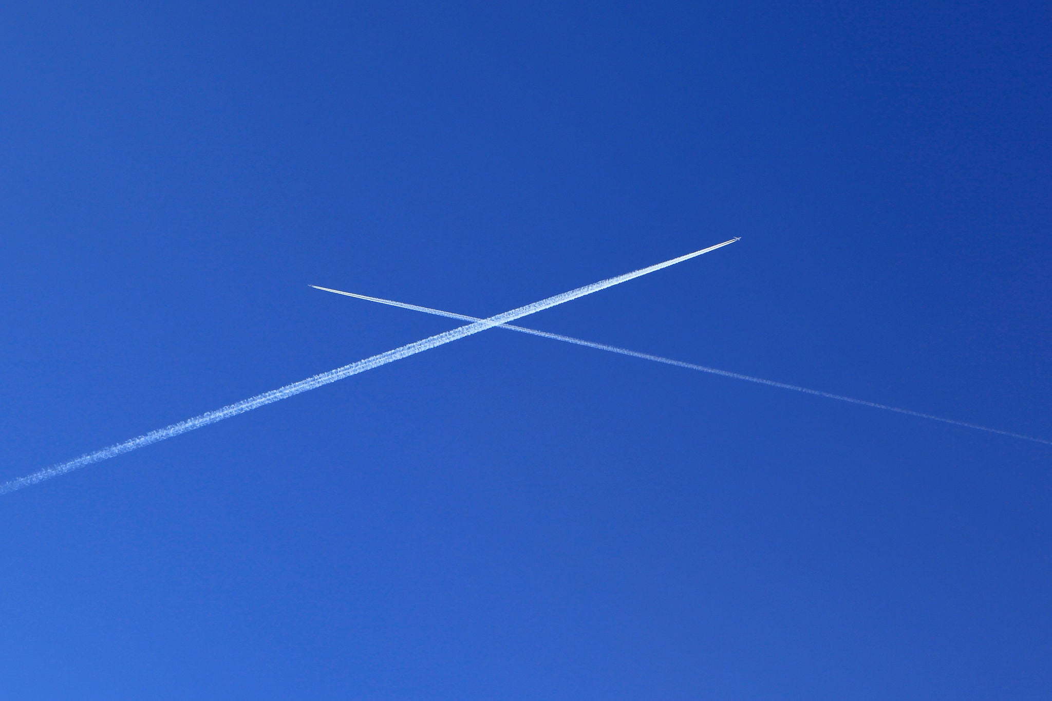 Planes crossing in blue sky