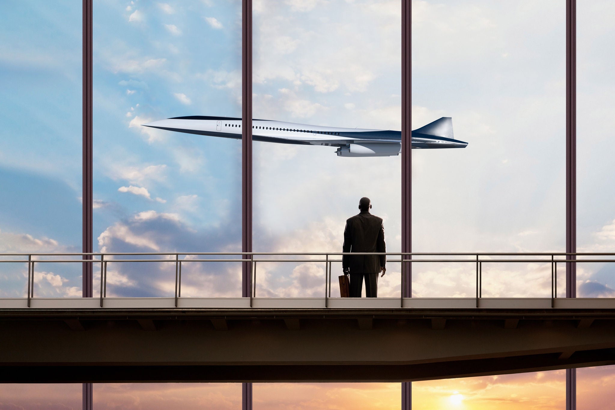 American businessman watching plane in sky