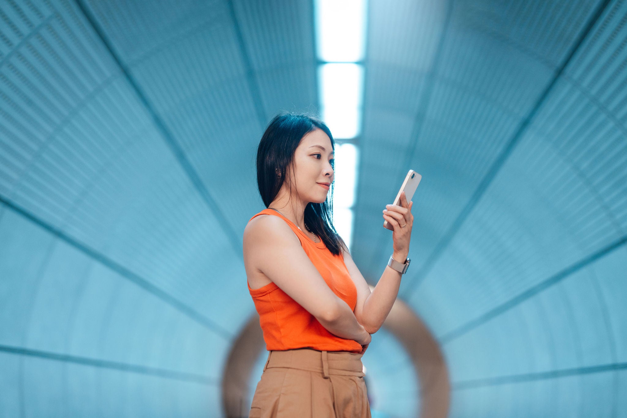 ey-young-asian-woman-using-smart-phone-in-a-futuristic-tunnel