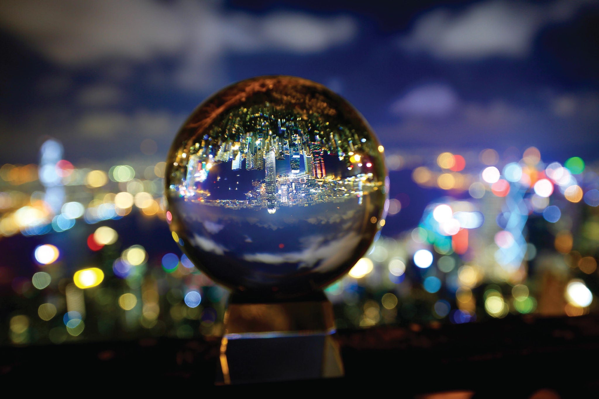 Reflection of a cityscape at night seen in a glass ball