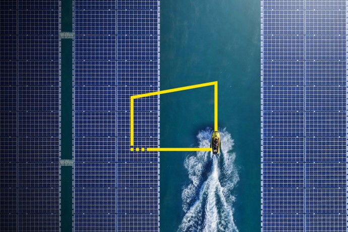 Aerial view of jetski between solar panels floating in a dam