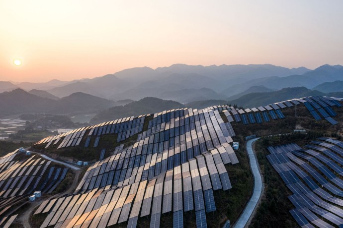 Solar power plant on the top of the mountain at sunset