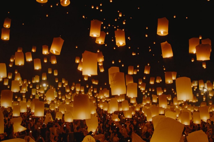 Sky lanterns lifting up into the night sky