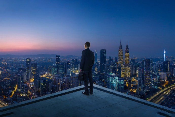 Businessman stand at rooftop looking great cityscape view and thinking business plan of the future. Night scene