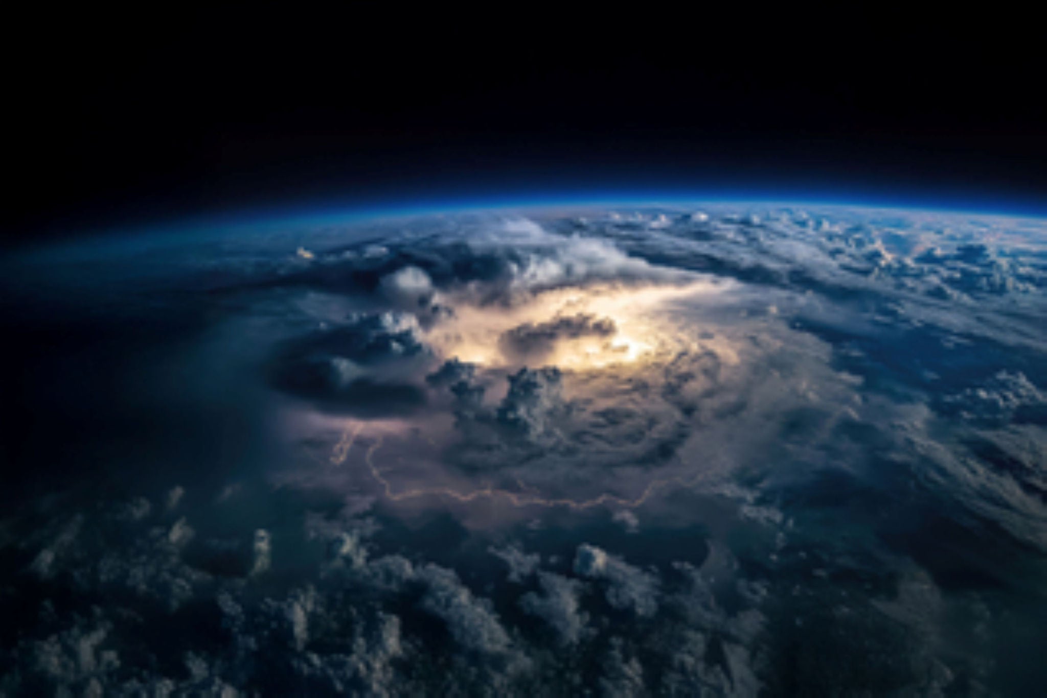 Storm clouds over Earth from space with glowing lightning center