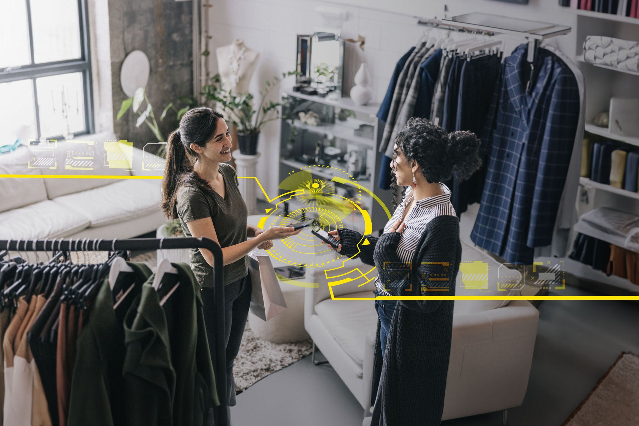 Portrait of a Latin woman, dressed in casual attire, holding her mobile phone as she makes a payment at a small business clothing store.