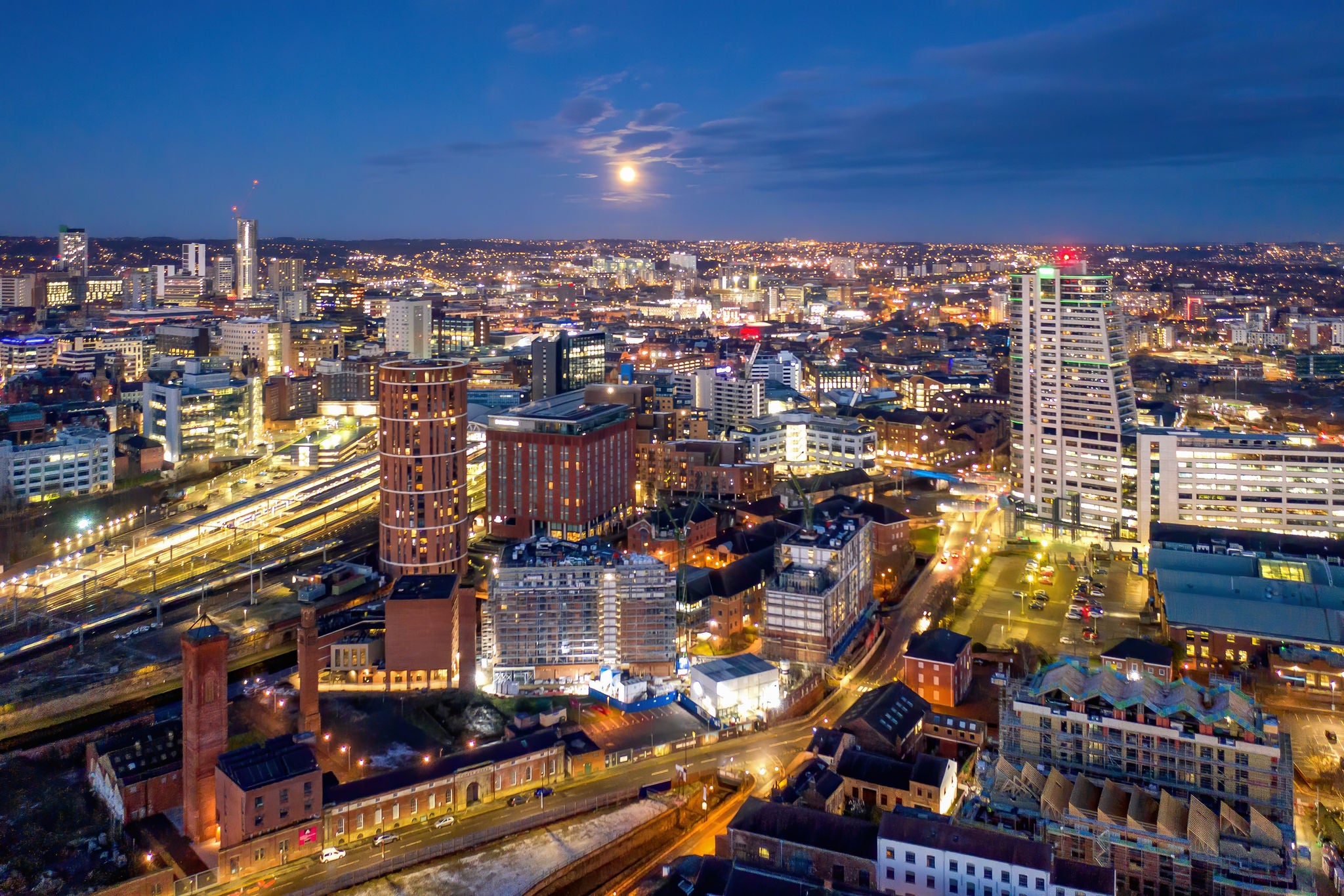Illuminated city skyline with buildings under a night sky