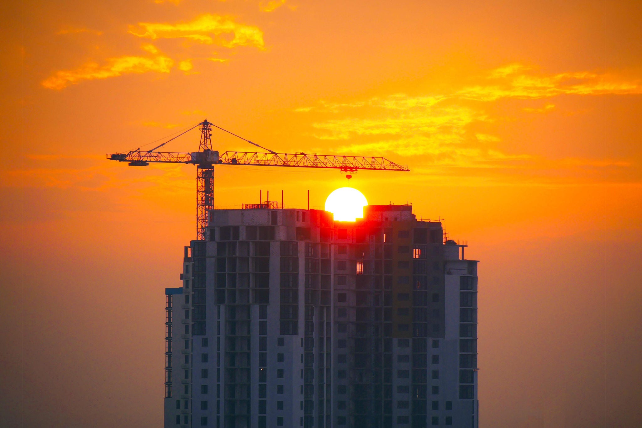 Building under construction at sunset