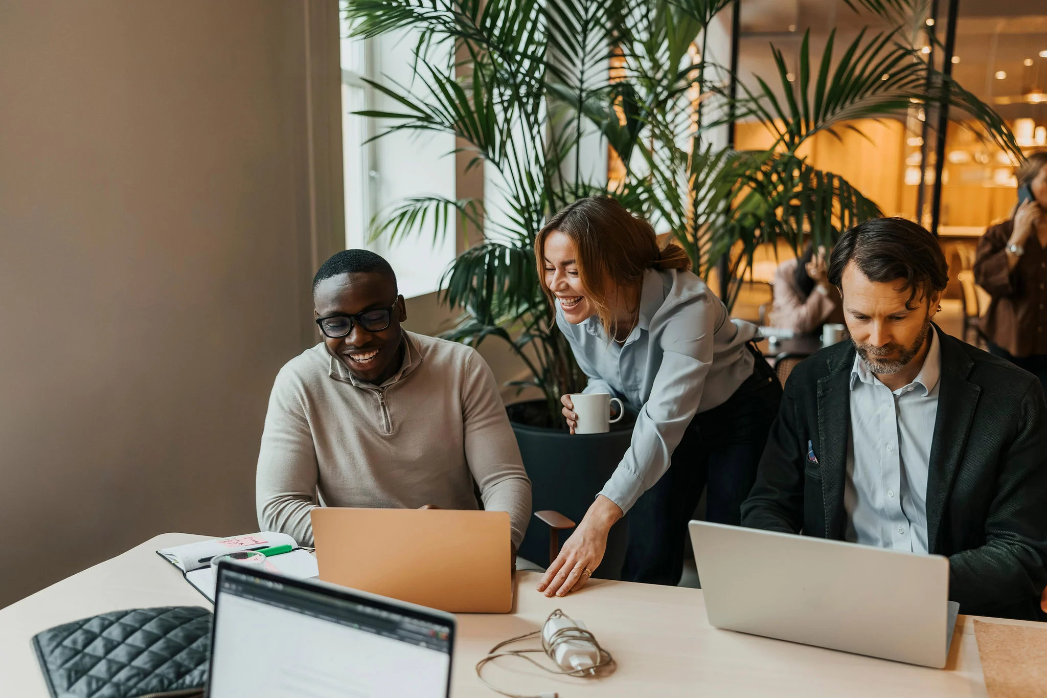Professionals collaborating in a modern office, using technology to support teamwork and business outcomes.