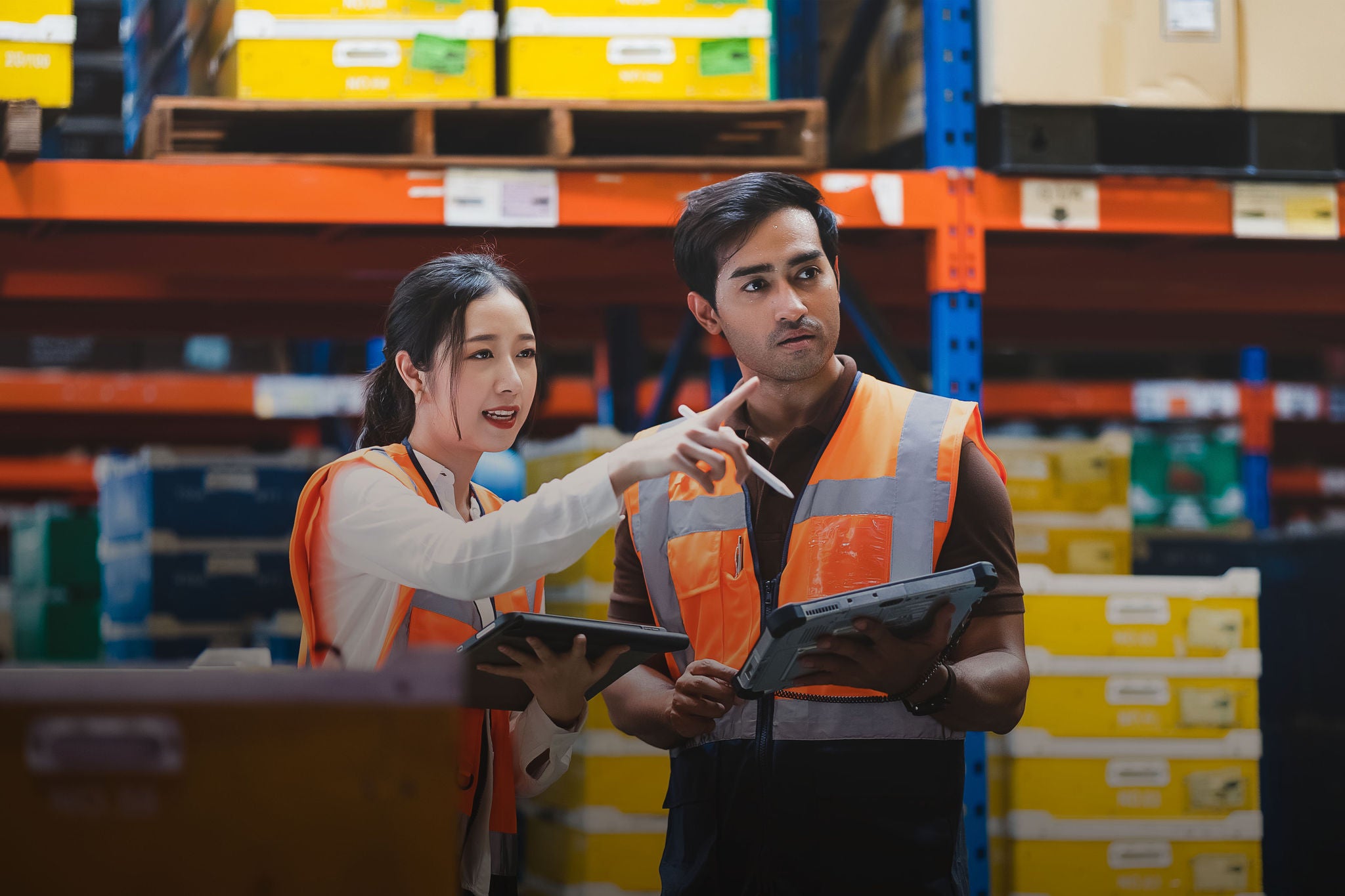 Warehouse worker and manager checks stock and inventory