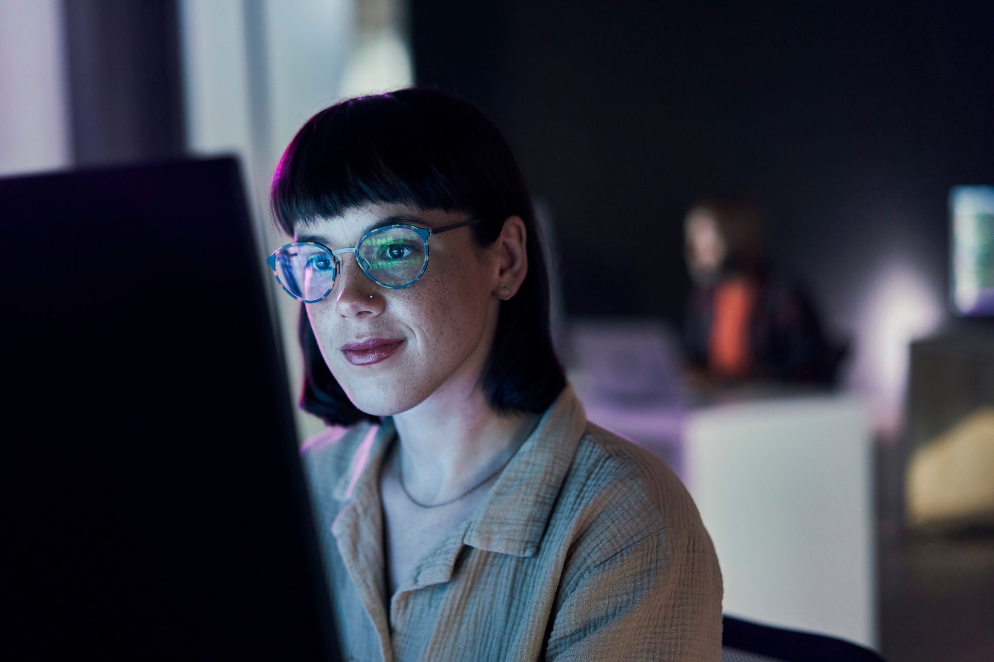 Business woman, computer seo work and coding of young employee with blue light and glasses.