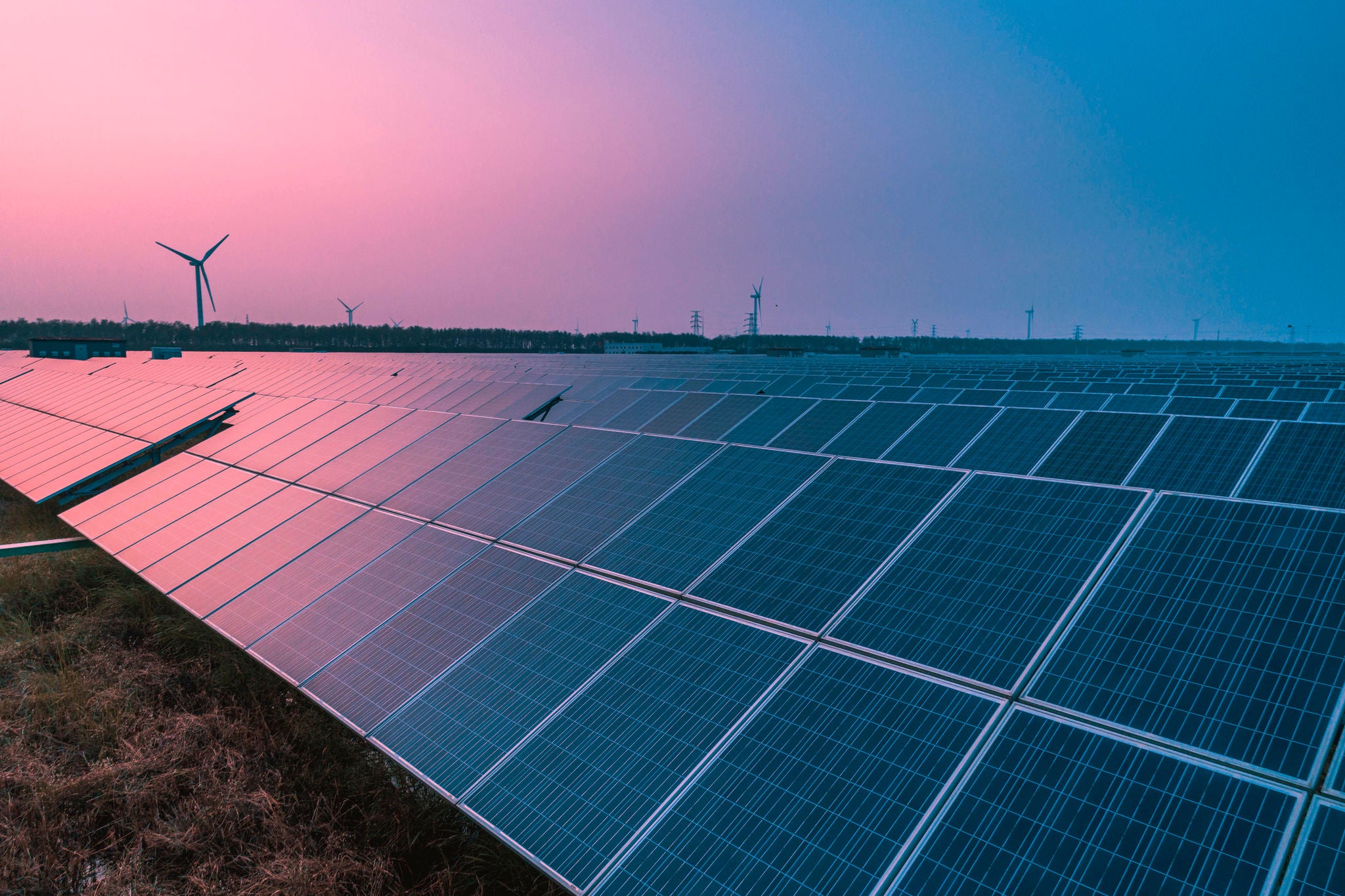 Solar panels with wind turbines on a sunny day
