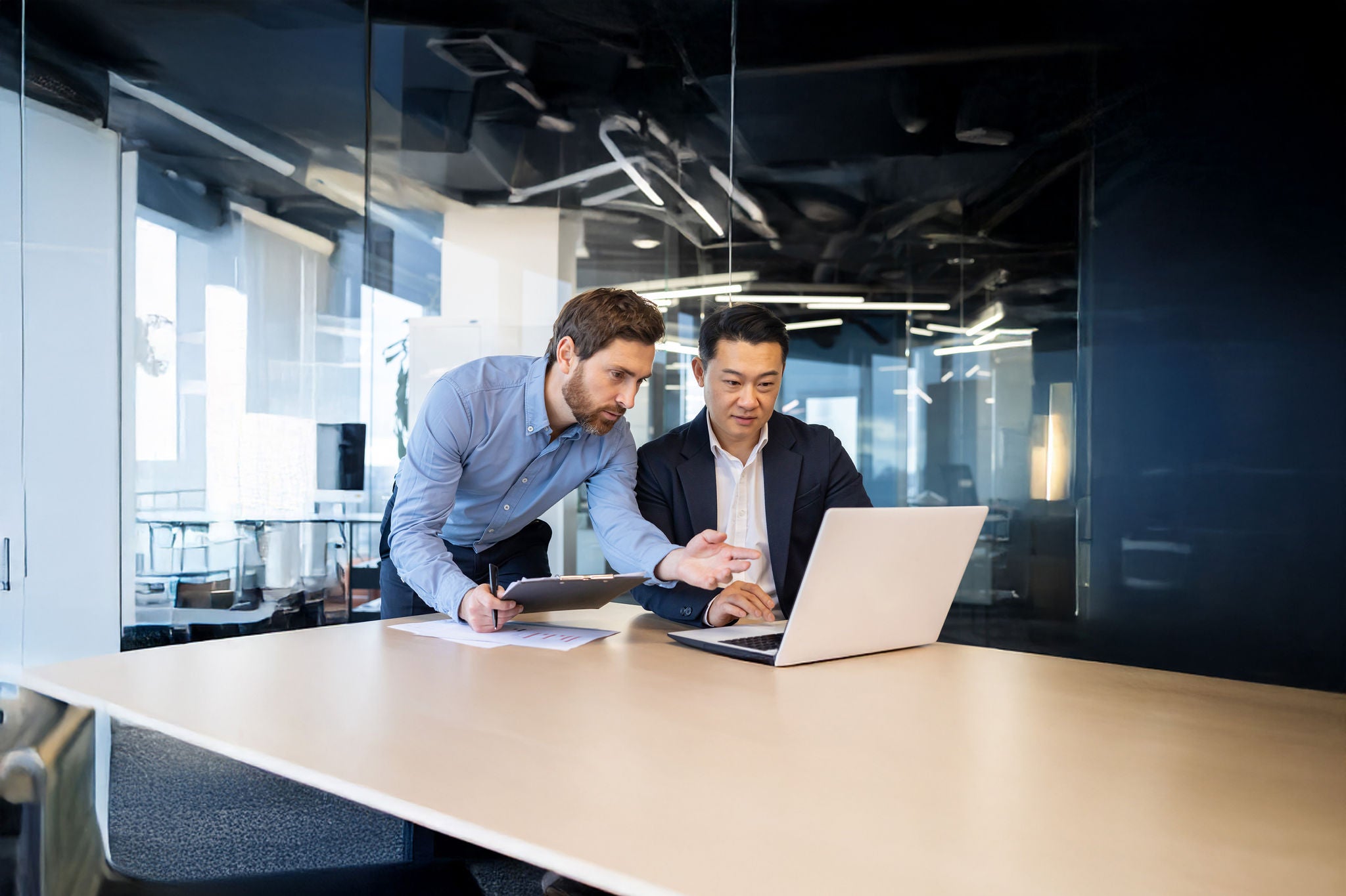 Business meeting, two business people serious concentrated discussing strategy and plan