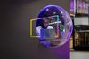 Man working on laptop seen through a plastic bubble window