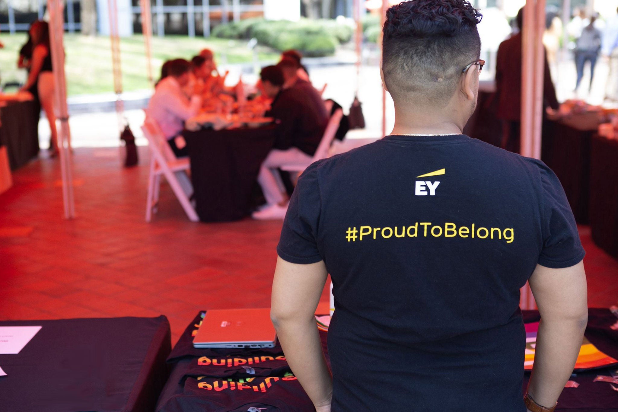 Person in an EY proud to belong tee shirt at an inclusiveness event