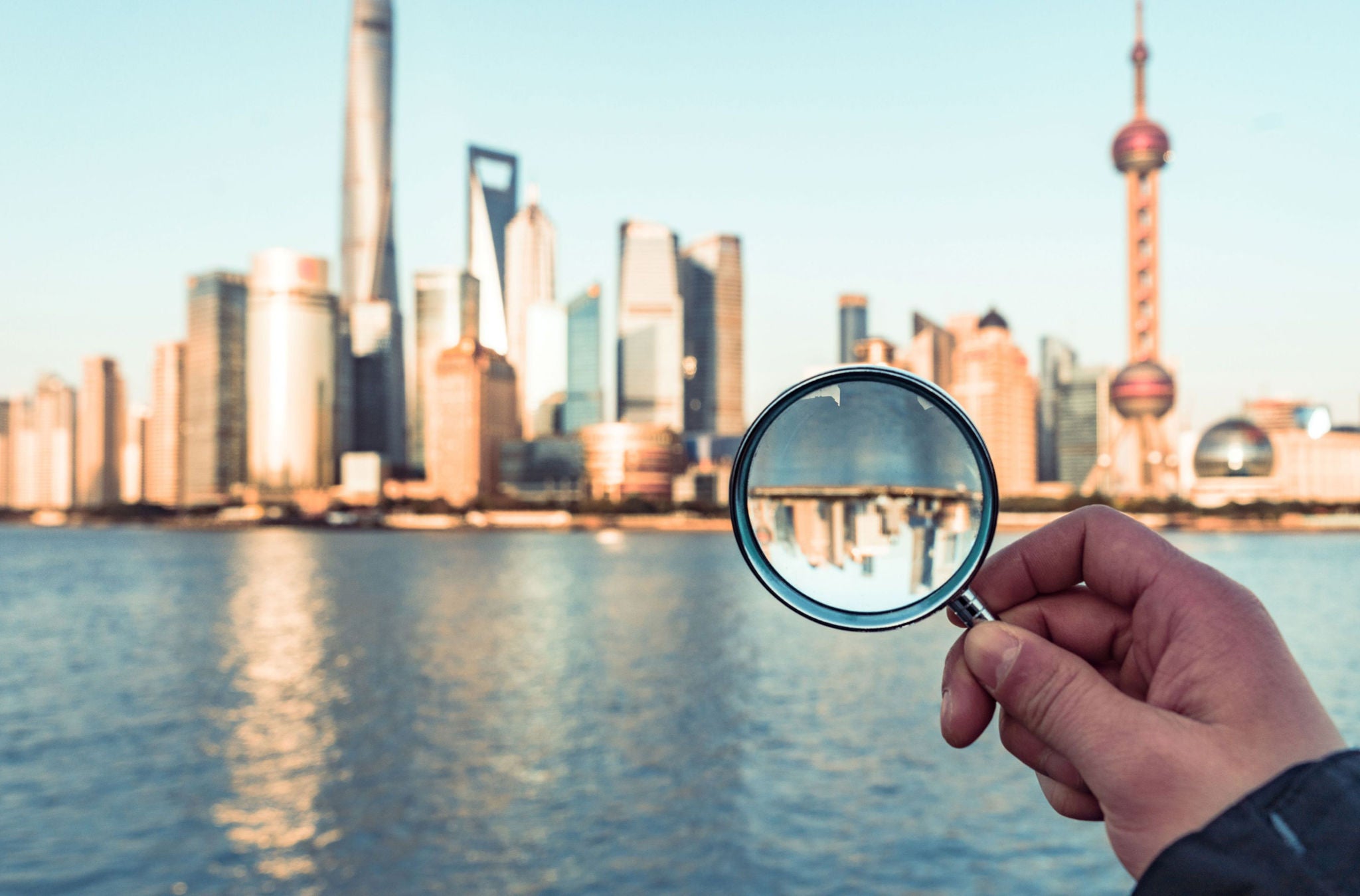 Magnifying glass above the city