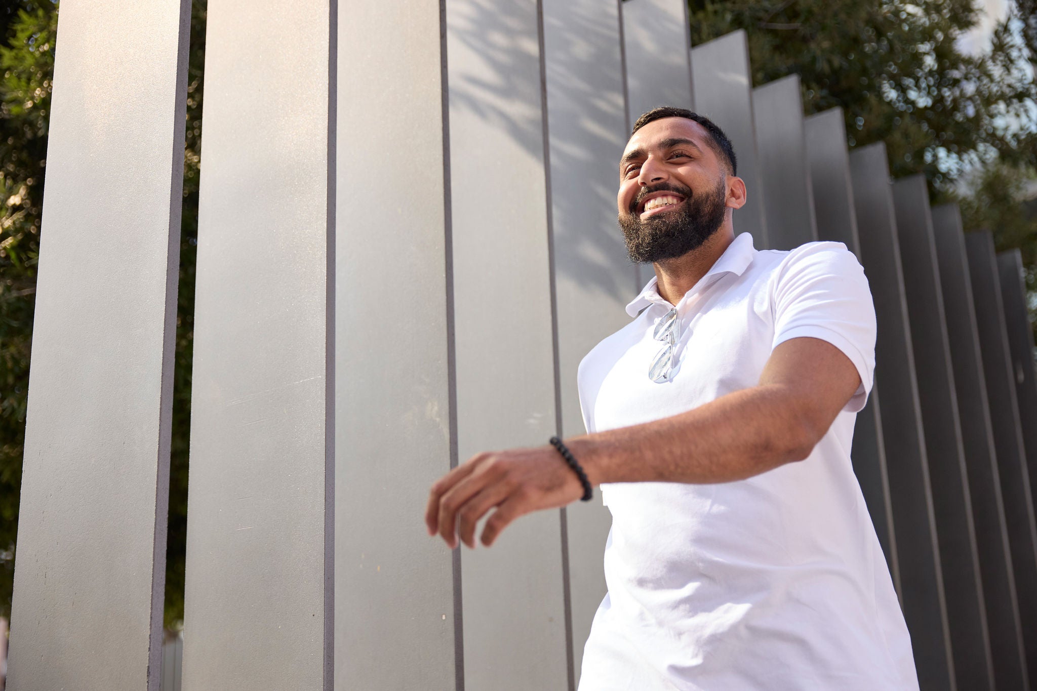 Person walking past a fence