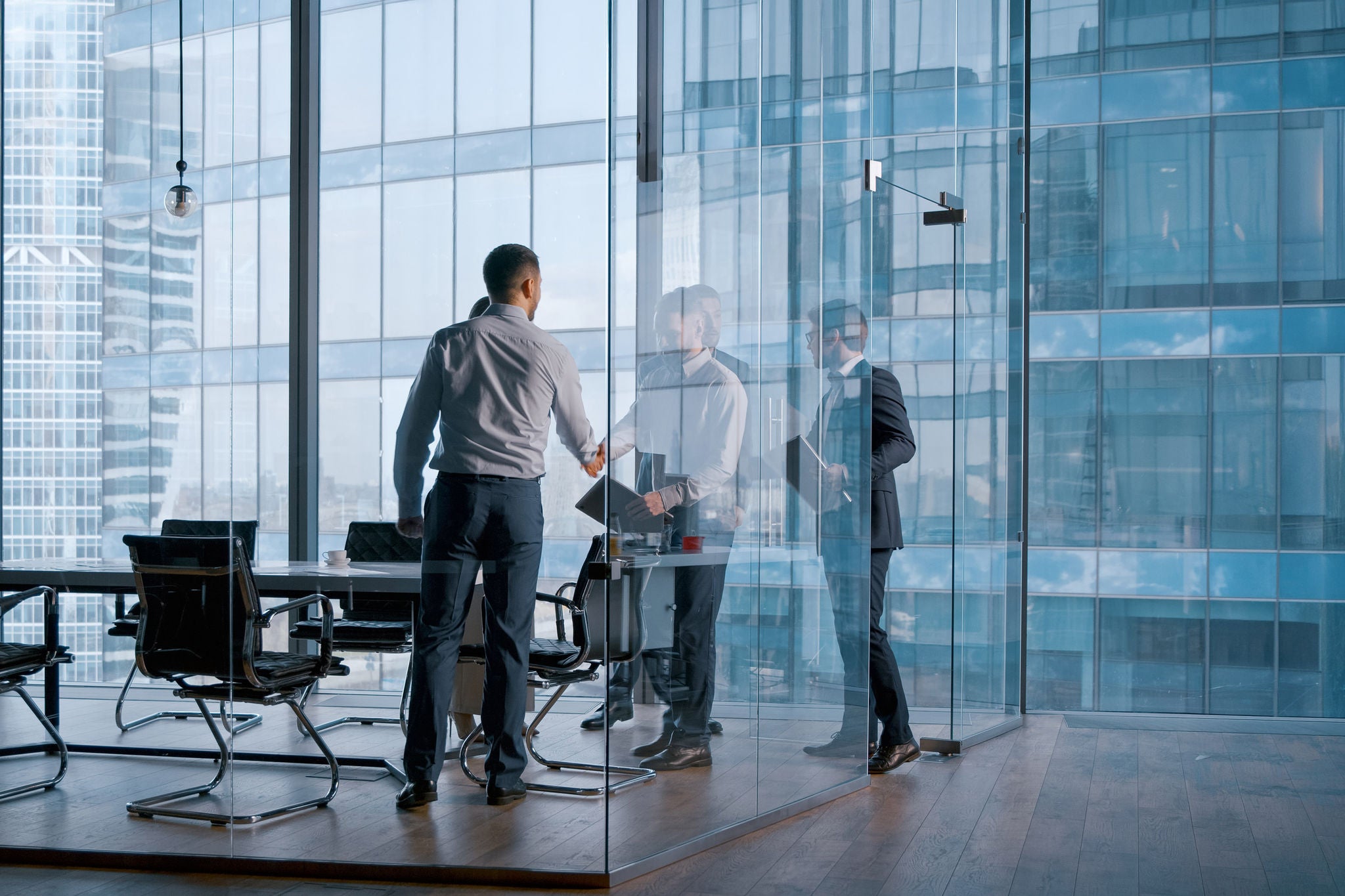 Office concept: meeting of business partners in a conference room to discuss new contracts