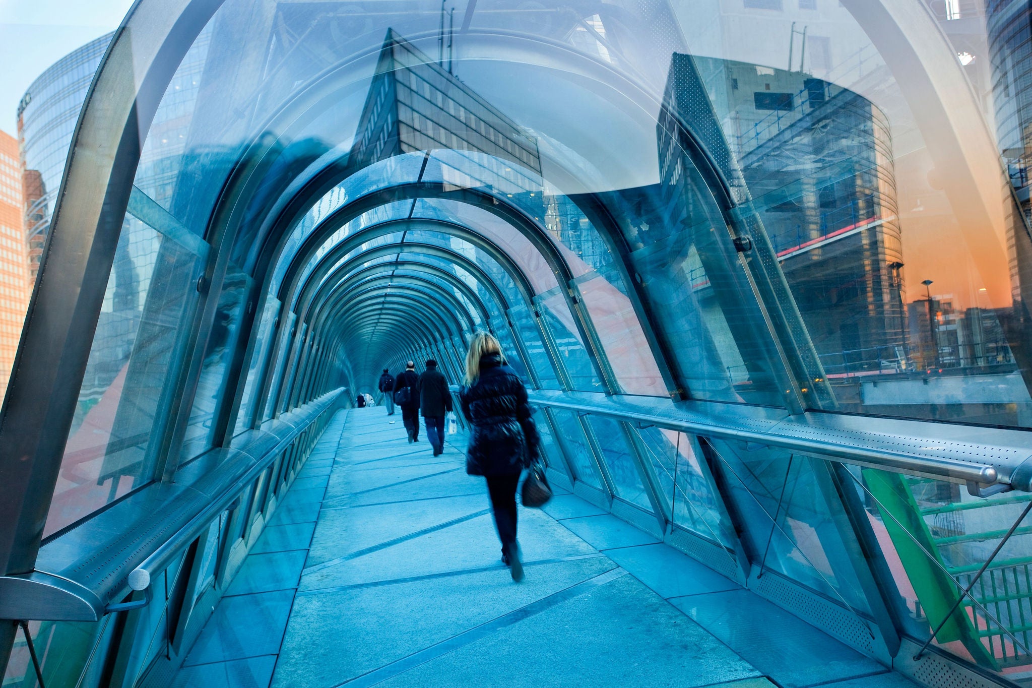 people walking under a French bridge