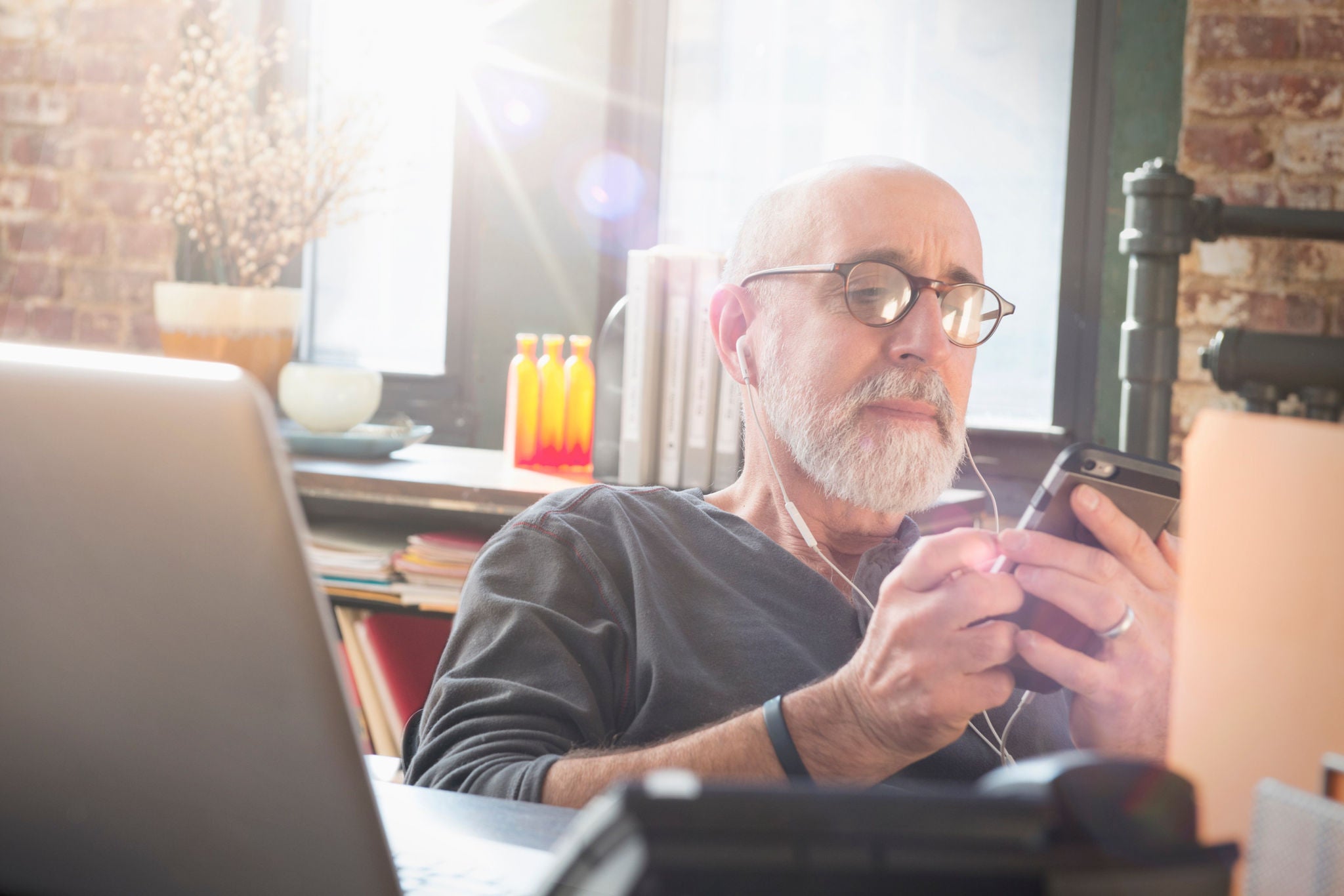 Businessman using cell phone in office