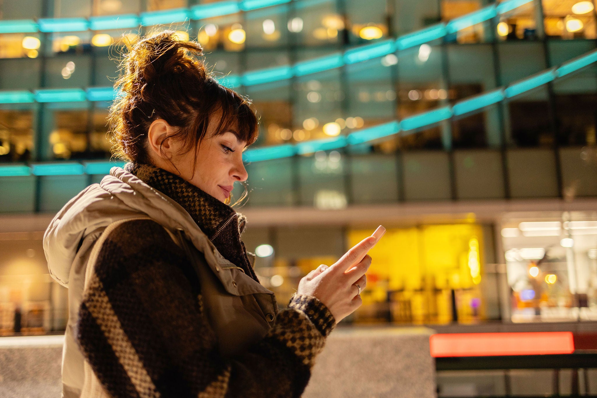 Woman with messy bun using smart phone