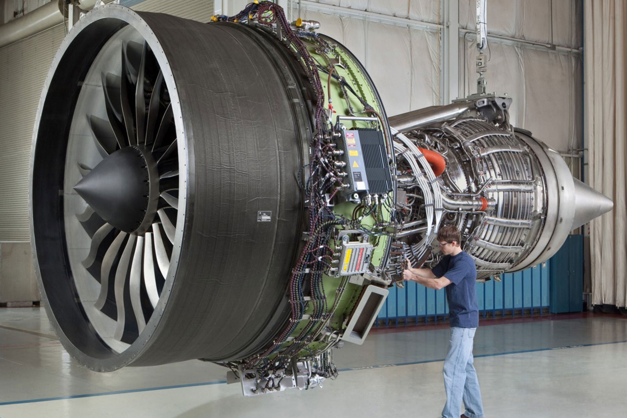 Giant interior jet engine, mechanic working