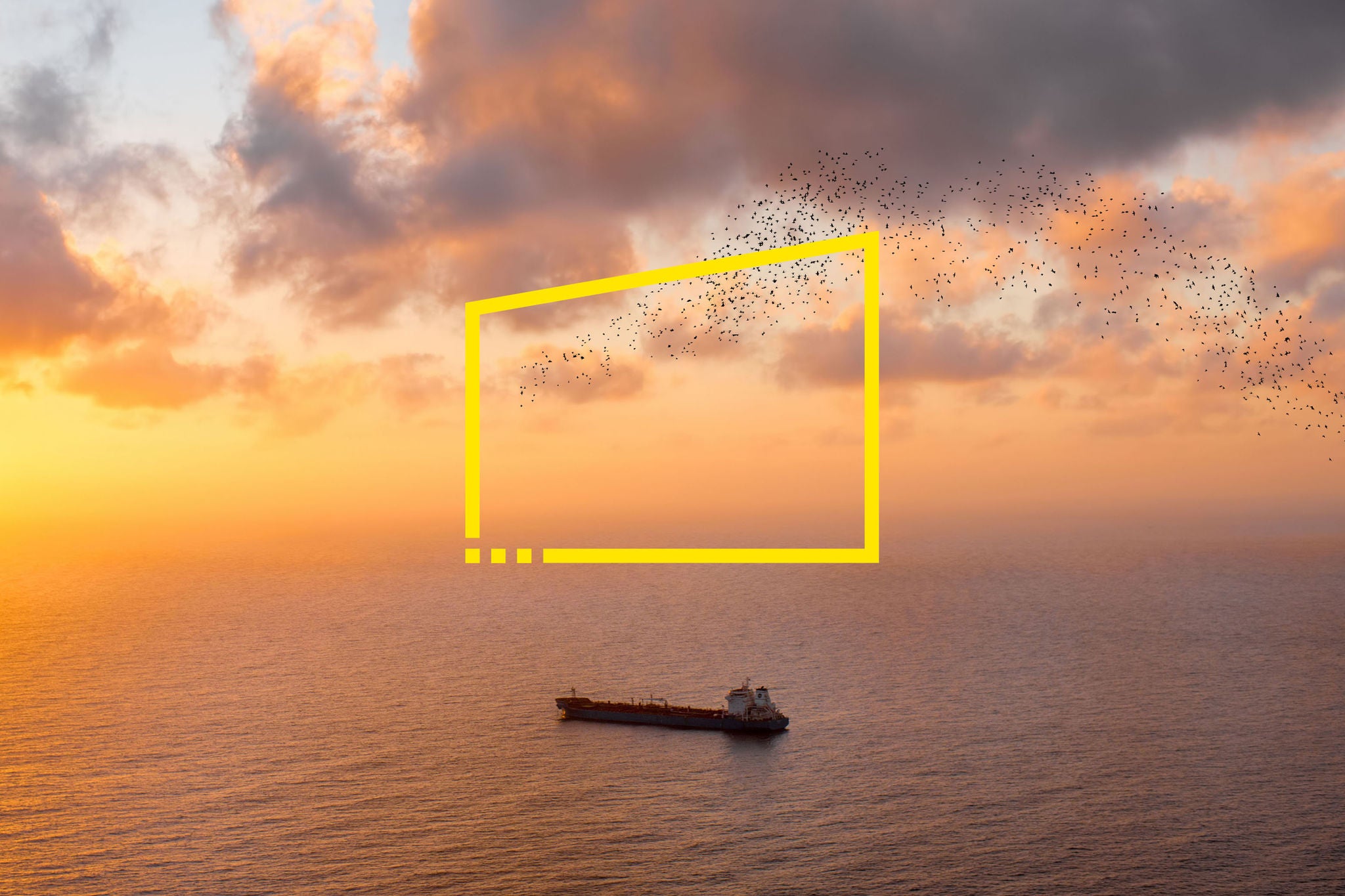 Cargo ship in the ocean on the sunrise. Wide angle view with copy space