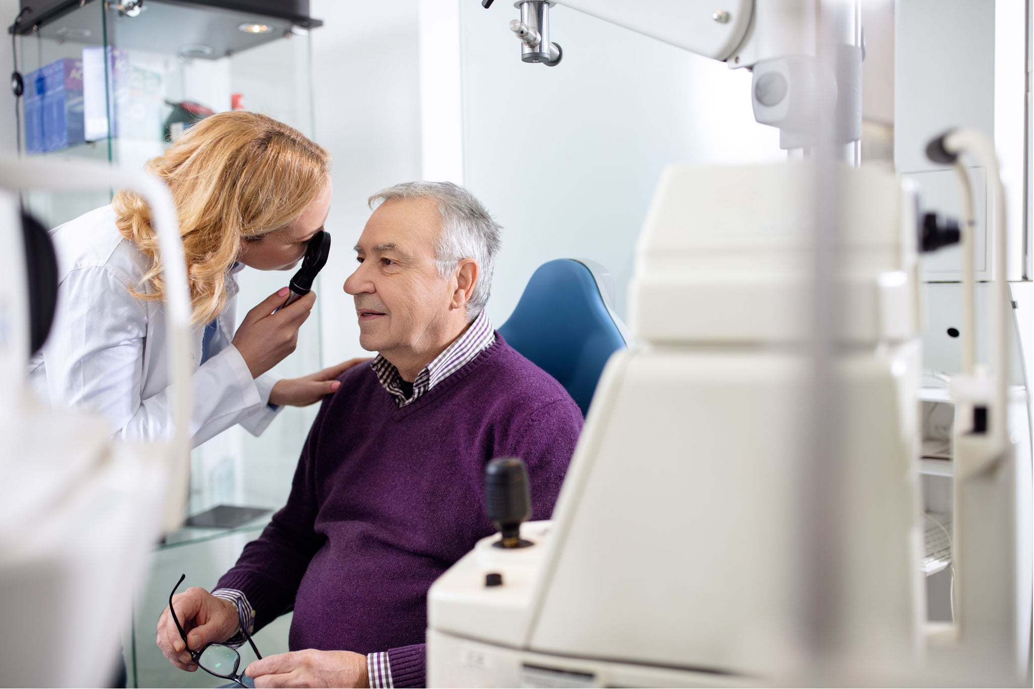 Female ophthalmologist determines diopter to elderly man