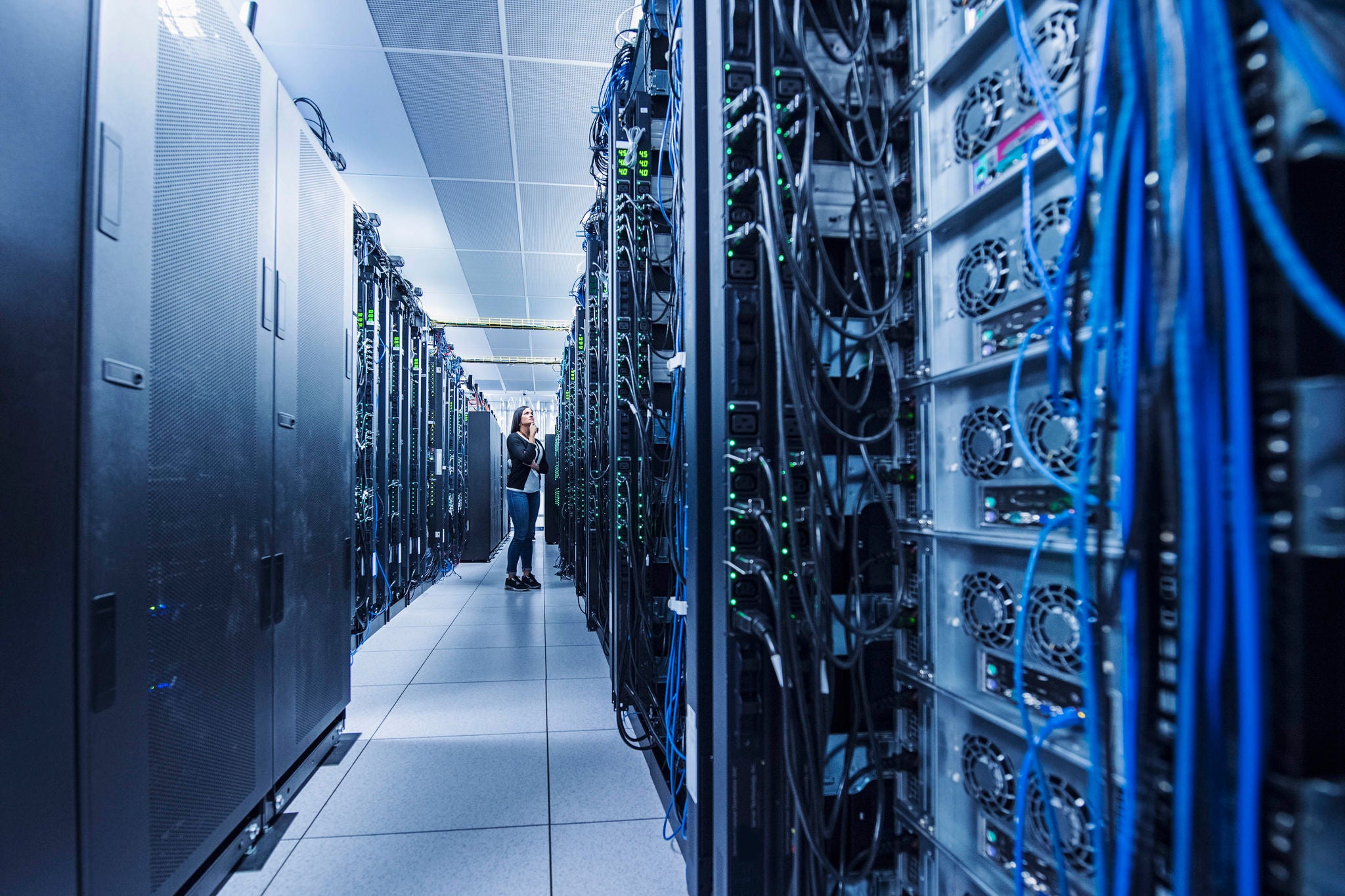 Female engineer working in a server room