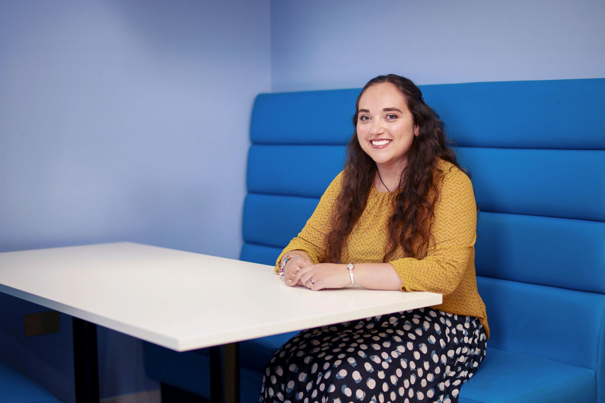 Office booth seating area with person at table