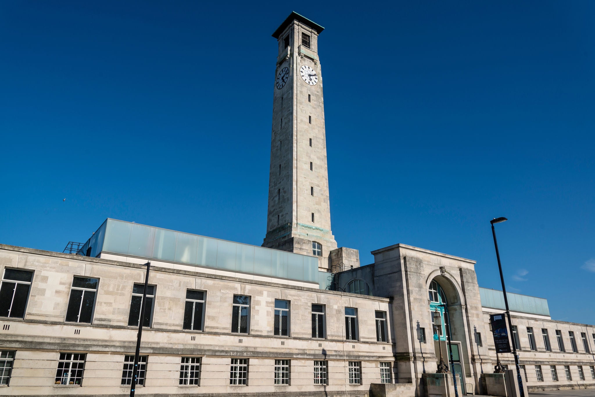 Historic museum building with clock tower under a clear sky