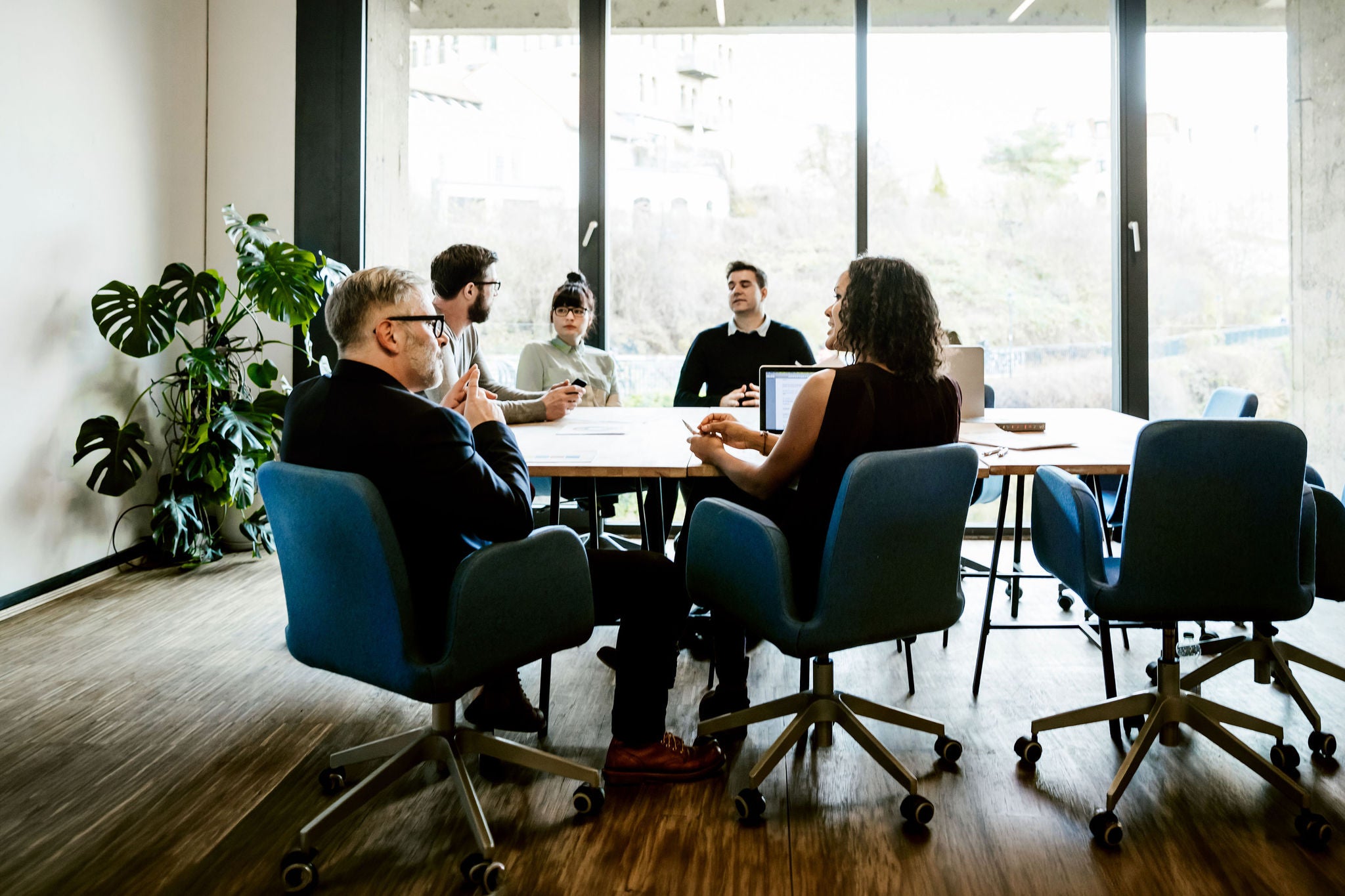 New business team sitting on a conference table in a modern office