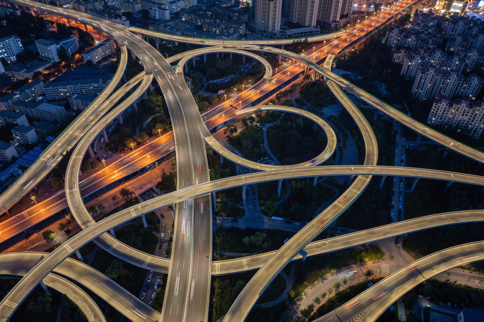 A mesmerizing drone shot captures the intricate dance of light and concrete at a vast, multi-level highway interchange in Xining, China, after dark.