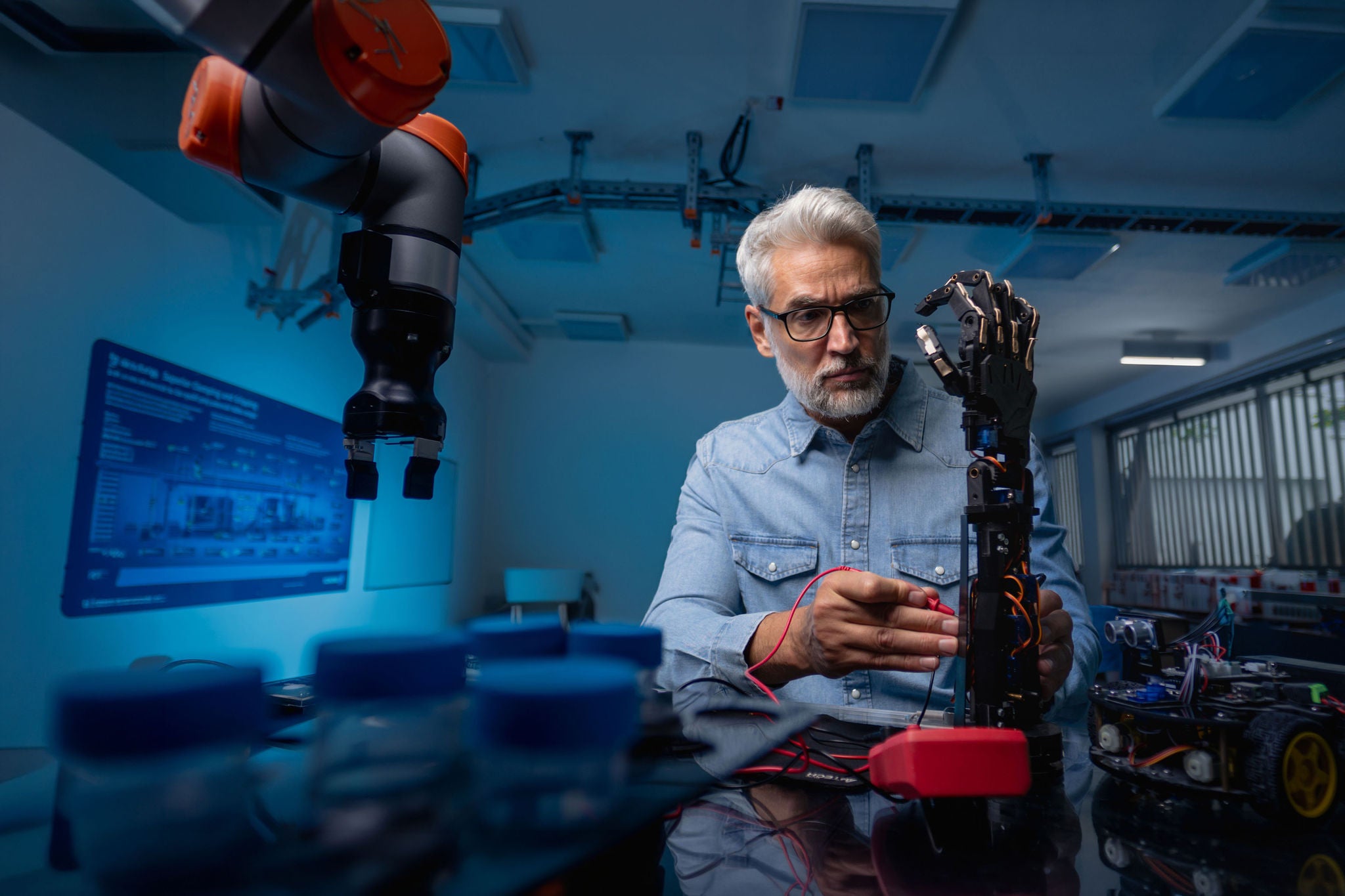 Robotics engineer calibring robotic prosthetic hand
