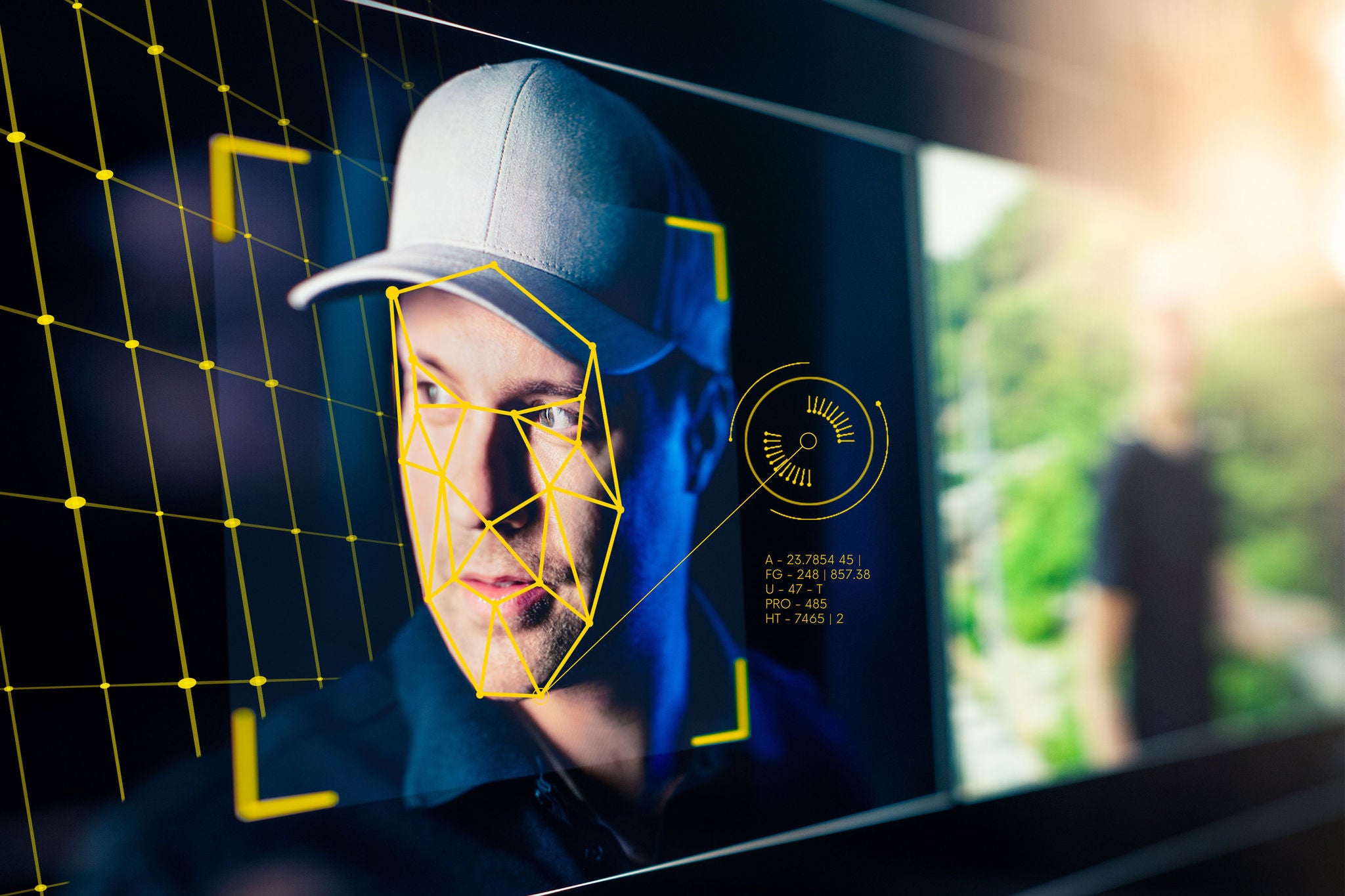 Man with baseball cap on AI facial recognition data scan
