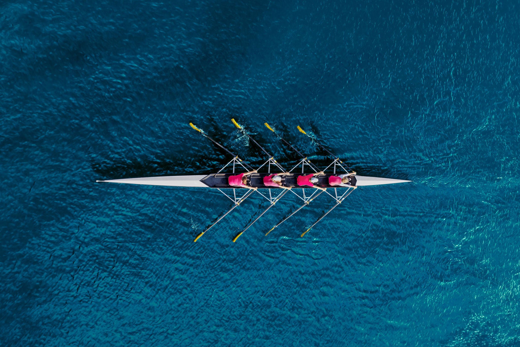 Women's rowing team on blue water