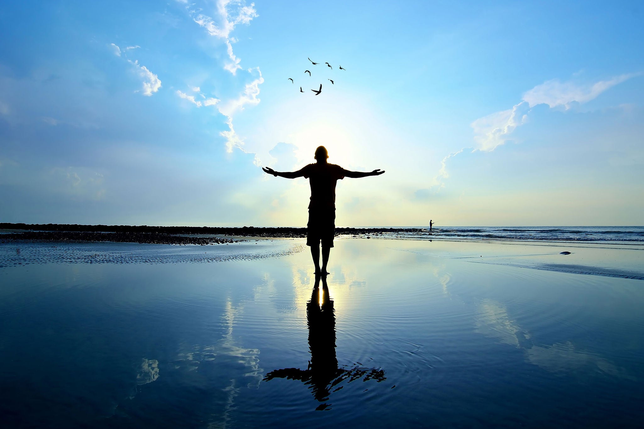 Silhouette of man raising his hands