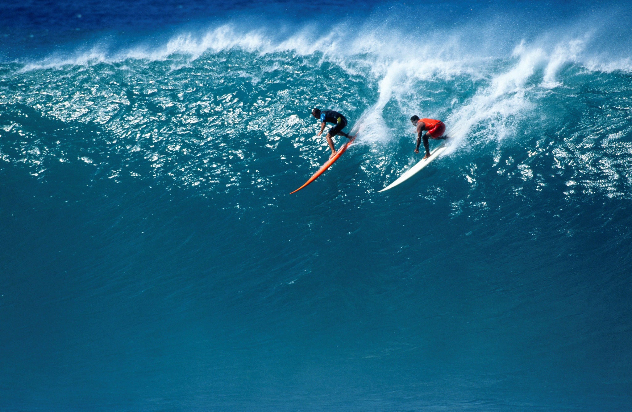 Two men preparing to surf