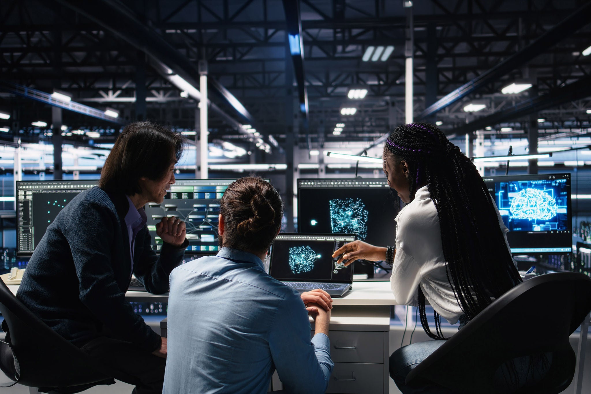 IT specialists in a server room use AI to analyze infrastructure diagnostics and performance data together.