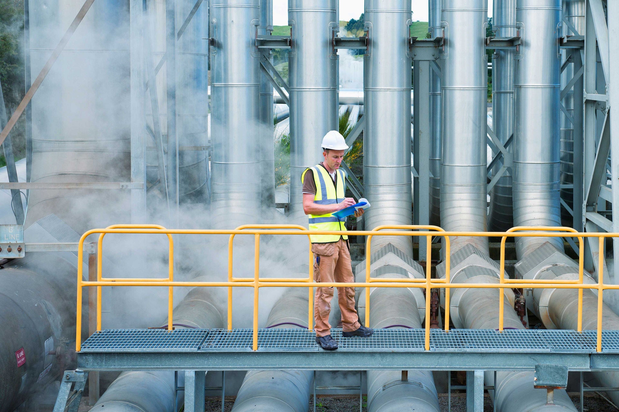 Two business people with wheelchair in the office working together. A man wearing VR goggles.