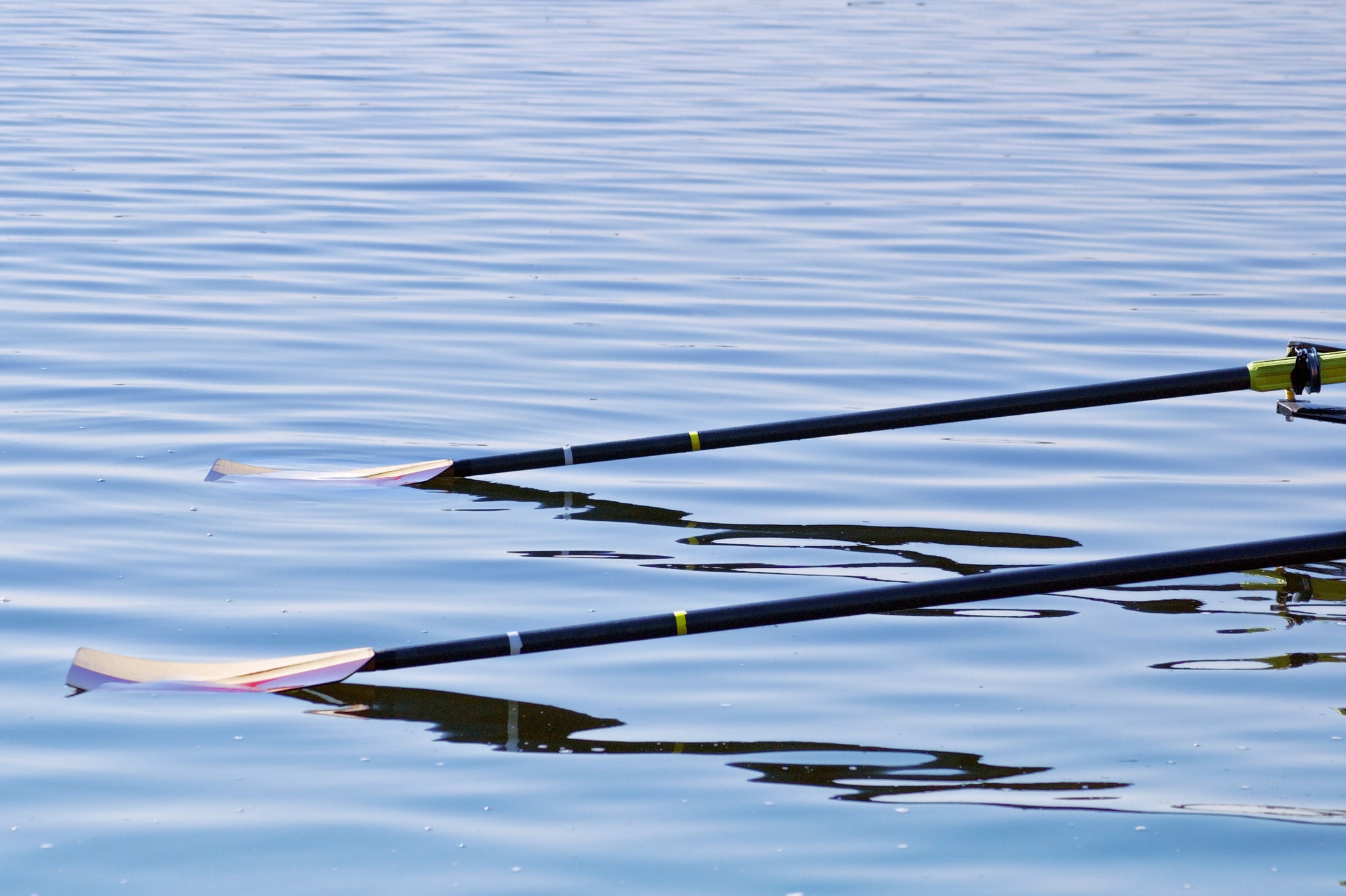 ey-rowing-oars-reflection-calm-water
