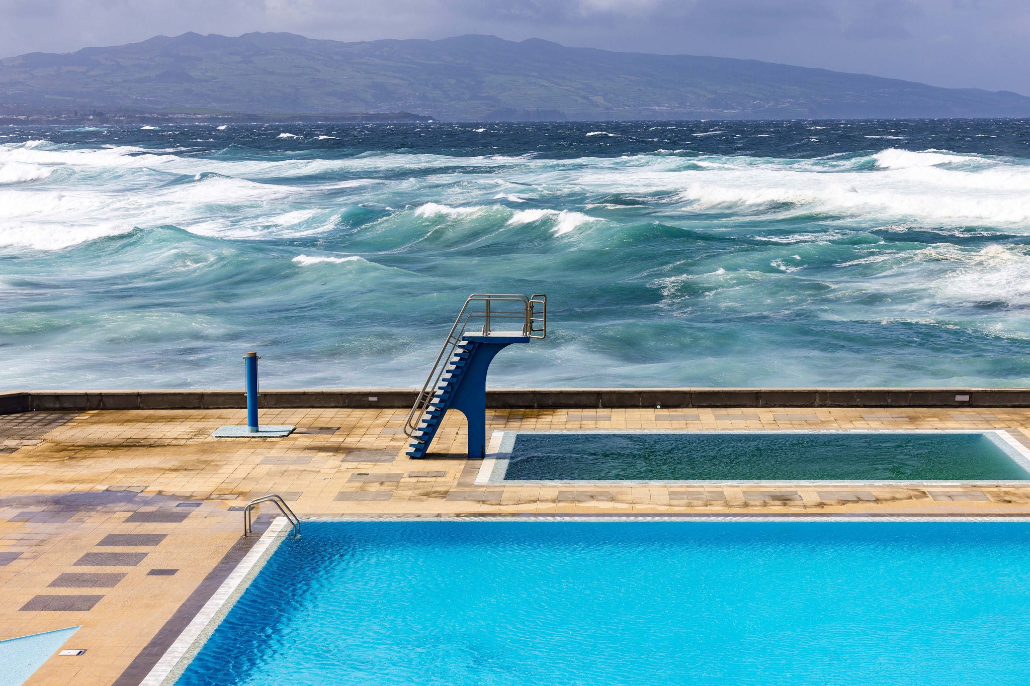Atlantic ocean and public swimming pool in ribeira grande, sao miguel island, Portugal.