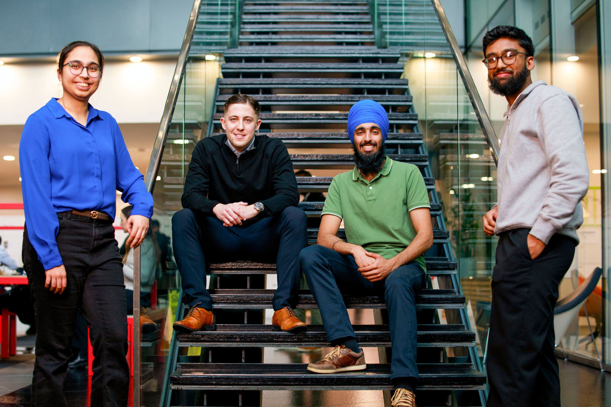 Colleagues standing by the stairs