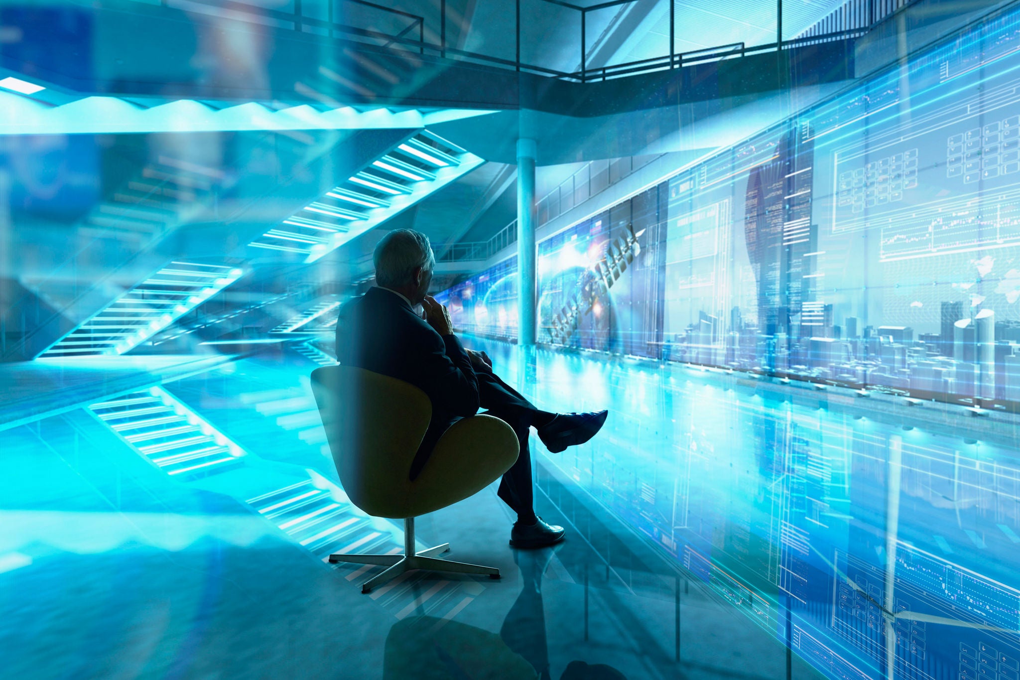 Businessman sitting on chair in futuristic office