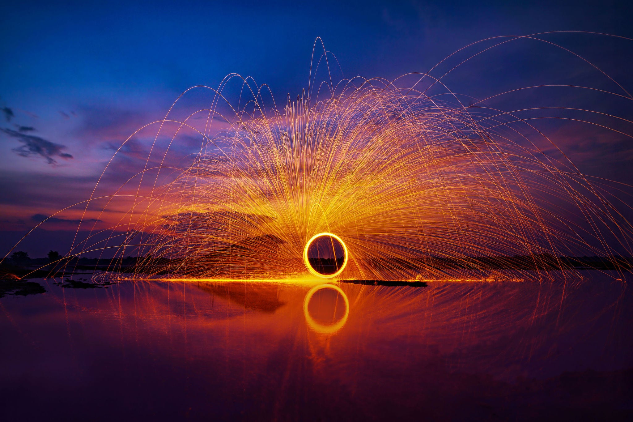 EY Entrepreneur Of The Year logo over a vibrant sunset backdrop.