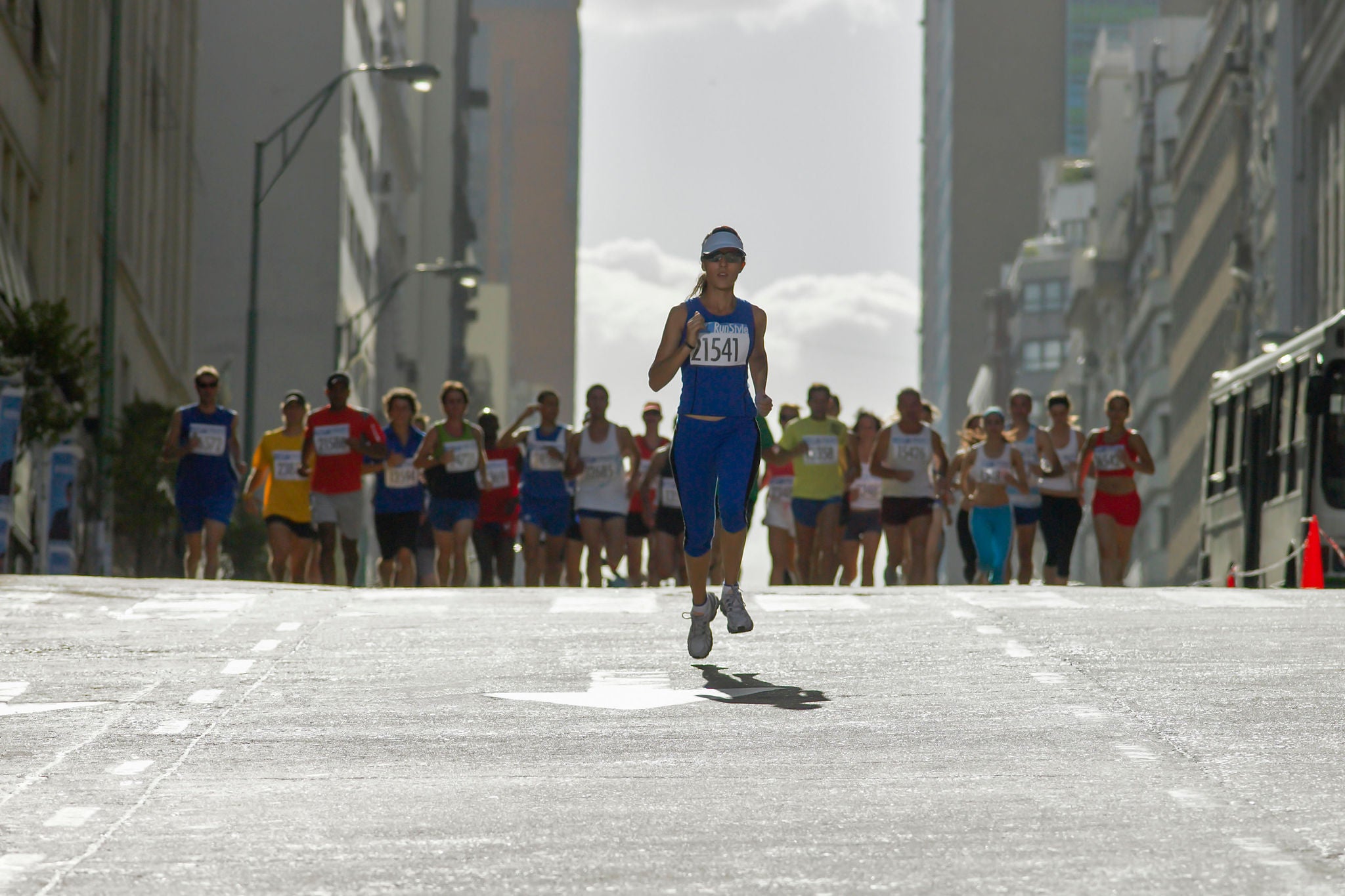 Woman running in front of pack in marathon