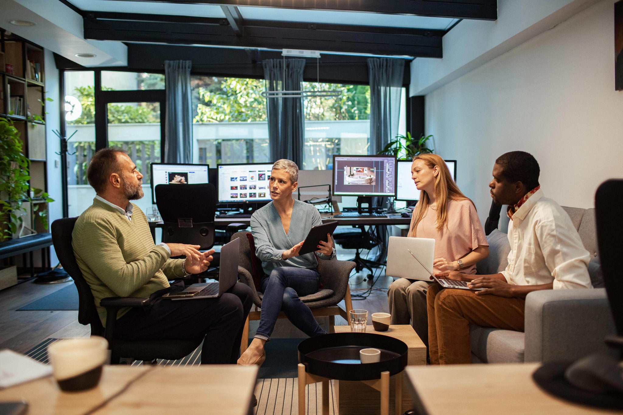 Business team brainstorming in modern office with natural light