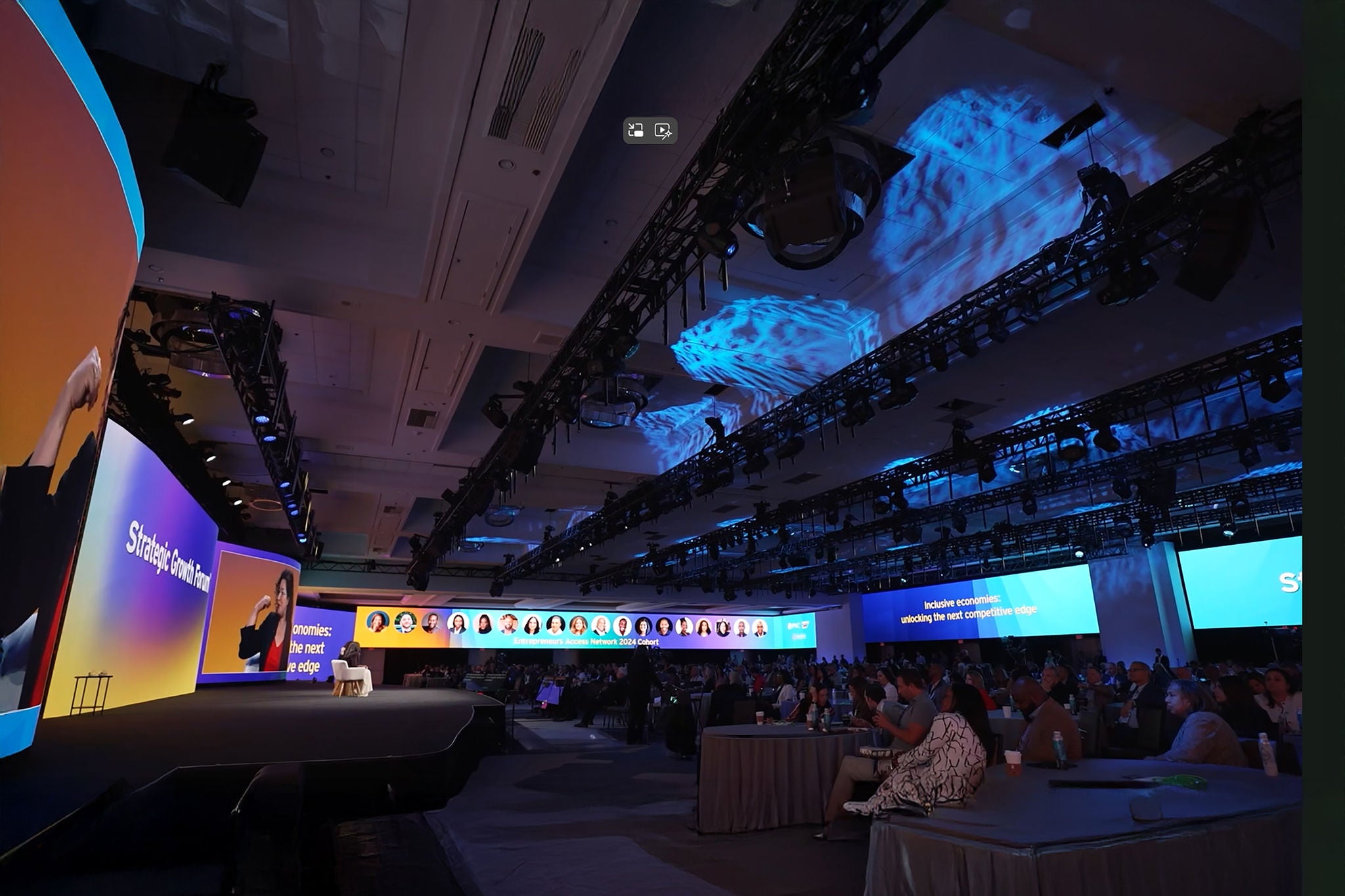 Many people in an event room watching SGF