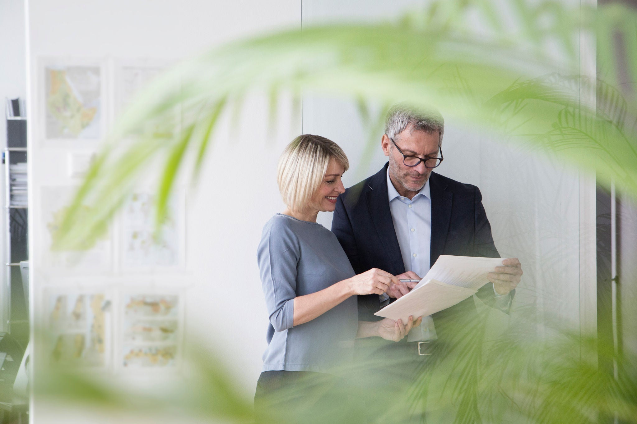 Two people looking at documents together in an office