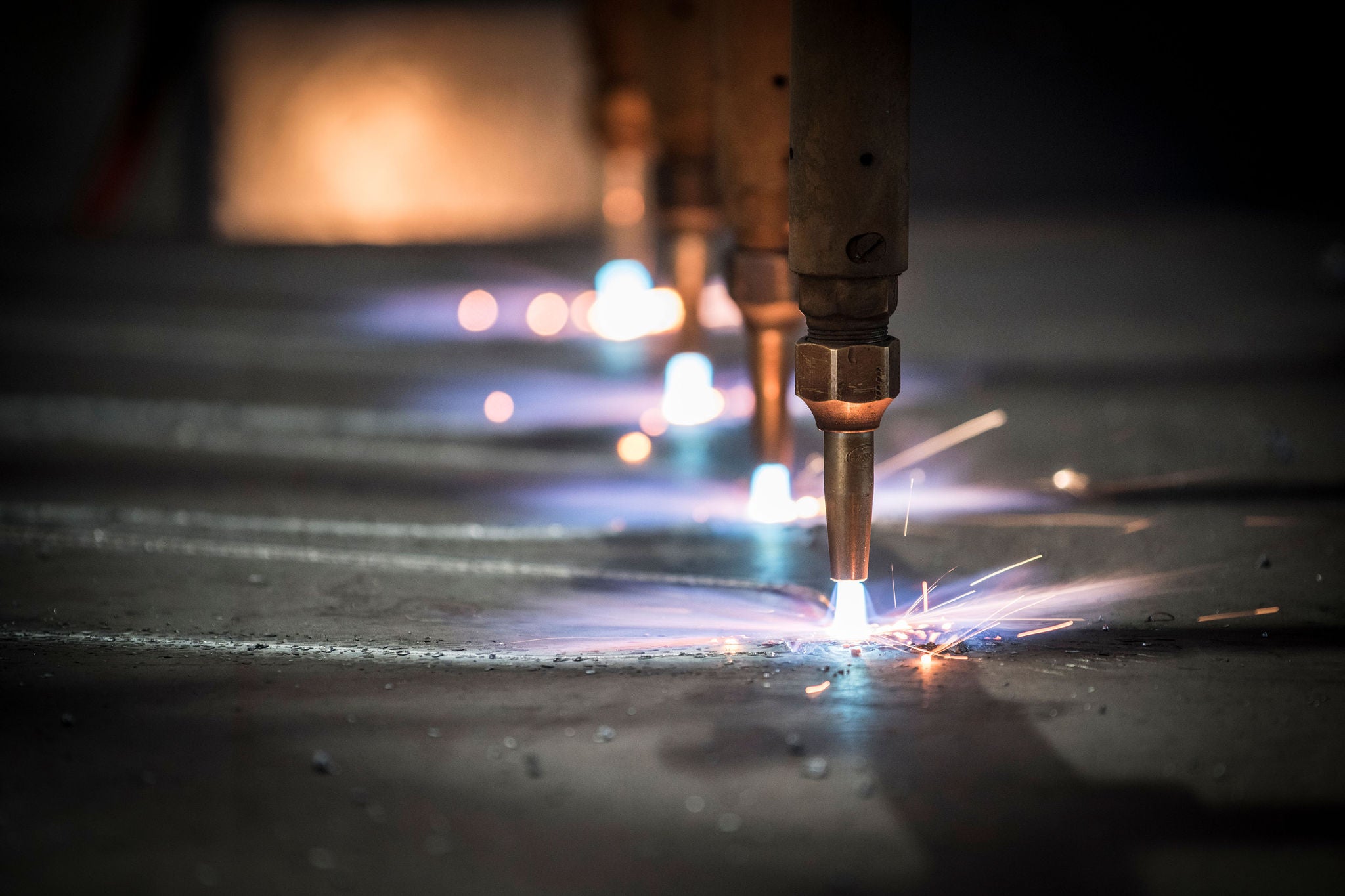 Metal cutting torches creating bright sparks